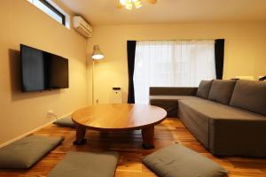 a living room with a couch and a table at Saifu House - Vacation STAY 29910v in Dazaifu