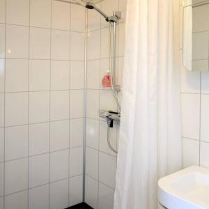 a bathroom with a shower with a shower curtain at Hagstua in Leknes