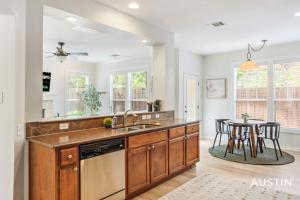 a kitchen with a sink and a table at Perfect Central Location w Free Prkg and Cozy Beds in Austin