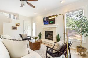 a living room with a couch and a fireplace at Perfect Central Location w Free Prkg and Cozy Beds in Austin