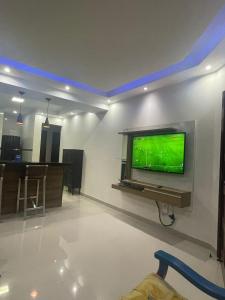 a living room with a flat screen tv on a wall at A Casa in Maricá +52 photos