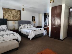 a hotel room with two beds and a couch at Maison plaza in Arequipa +17 photos
