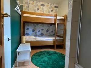 a bedroom with bunk beds and a green wall at Picture perfect Holiday Home in Sourbrodt with Garden BBQ in Sourbrodt