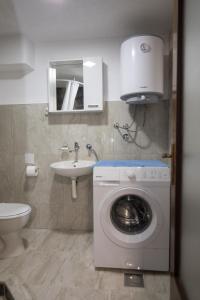 a bathroom with a washing machine and a sink at Apartman Božur in Trebinje +16 photos