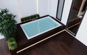 a jacuzzi tub in a room with plants at Richico Apartments And Hotel in Da Nang