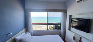 Μια τηλεόραση ή/και κέντρο ψυχαγωγίας στο Flat Brisa - Hotel Mercure Navegantes