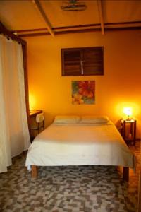 a bedroom with a white bed in a room at Villas Advi in Puerto Viejo