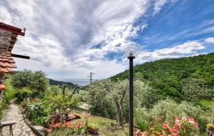 a street light in a garden with mountains in the background at 1 Bedroom Nice Apartment In Moneglia in Moneglia