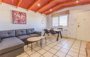 a living room with a couch and a table at Cozy Home In San Pedro Del Pinatar in San Pedro del Pinatar