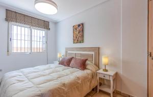 a bedroom with a large bed and two lamps at Cozy Home In San Pedro Del Pinatar in San Pedro del Pinatar