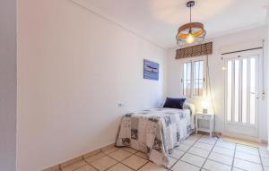 a bedroom with a bed in a room with a window at Cozy Home In San Pedro Del Pinatar in San Pedro del Pinatar +16 photos