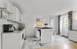 a kitchen with white cabinets and a counter top at Lejl 3 in Brovst
