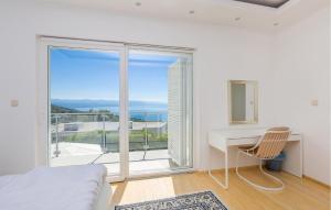 a white bedroom with a desk and a large window at 5 Bedroom Lovely Home In Poljane in Poljane +31 photos