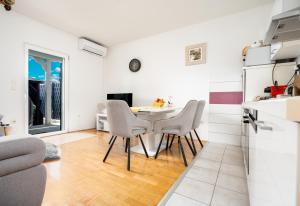 a kitchen and dining room with a table and chairs at Holiday house with a parking space Dugi Rat, Omis - 23046 in Dugi Rat