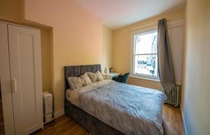 a bedroom with a bed and a window at Central quality point piccadilly in London