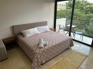 a bedroom with a bed and a large window at Smart Home luxury Condo in Playa del Carmen +12 photos