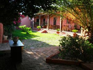 a garden with a brick path in front of a house at Il Vigneto B&B in Gonnesa