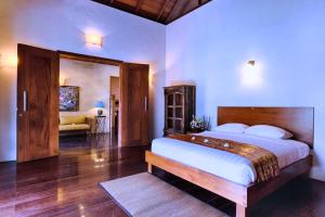 a bedroom with a large bed in a room at Leah 6 BR Private Pool Villa JU26 in Ketewel +23 photos