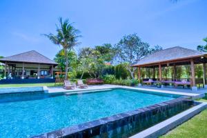 a swimming pool in a yard with a gazebo at Leah 6 BR Private Pool Villa JU26 in Ketewel
