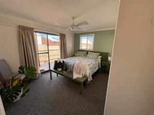 a bedroom with a bed and a window at Hills of Gold Motel at Nundle in Nundle