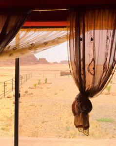 a curtain hanging from a tent in the desert at Shakria Bedouin Life Camp in Wadi Rum
