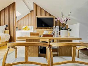 a bedroom with a desk with two chairs and a tv at 北京悦明元星空白塔景观四合院民宿 in Beijing