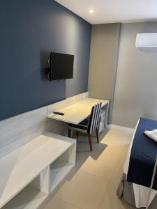 a room with a desk and a tv and a bed at hihome - Royale in Cabo Frio +46 photos