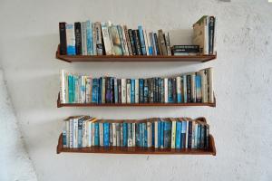 two wooden shelves with books on a wall at Attara Hills Sunset Villa Senggigi in Senggigi 