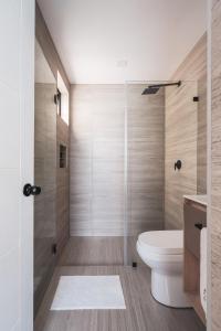 a bathroom with a toilet and a shower at Second Home Tamesis in Mexico City +20 photos