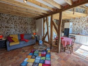 a living room with a couch and a table at Chaleureux Gîte avec Terrasse à Proximité de la Loire et des Sites Touristiques - FR-1-590-433 in Bonnée