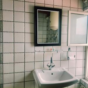 a bathroom with a sink and a mirror at Jaishnavi Homestay And Restaurant in Mukteswar