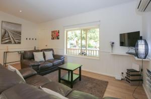 a living room with a couch and a television at Silver Birches Holiday Village - Unit 1 in Bright
