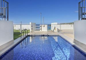 a large swimming pool on top of a building at Stunning Ocean Views With Manly At Your Doorstep in Sydney