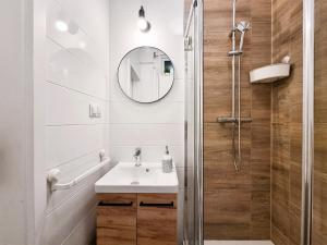 a bathroom with a sink and a shower at CLASSY APARTMENTS - Gdynia - Experyment in Gdynia