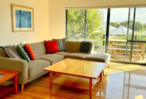 a living room with a couch and a coffee table at Margaret River Beach Houses in Gnarabup