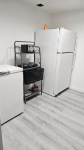a kitchen with two white refrigerators in a room at Bright and Cozy Room with Free Parking in Edmonton