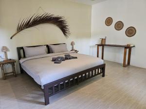 a bedroom with a large bed with hats on it at The Mellow Mango in Ko Lanta
