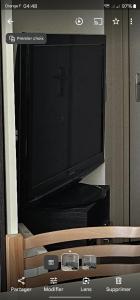a flat screen tv sitting on top of a dresser at Mobil home La palmyre 8 Pers in Les Mathes