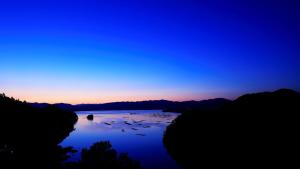 a view of a lake with birds in the water at Resorpia Kumihama in Kyotango