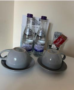 two bottles of water and a tea set on a table at Half Moon Inn in Middlesbrough