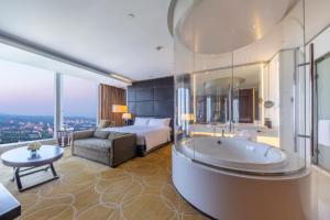 a hotel room with a tub and a bed at InterContinental Nanjing, an IHG Hotel in Nanjing