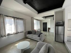 a living room with a couch and a table at Biei Villa Gen in Biei