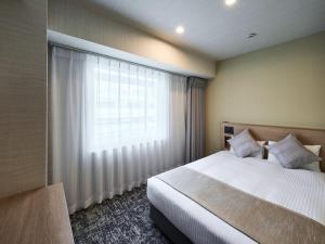 Postel nebo postele na pokoji v ubytování Hotel Villa Fontaine Tokyo-Kayabacho