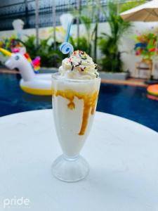 a drink with ice cream and whipped cream and sprinkles at Pride Resort Cambodia in Phnom Penh