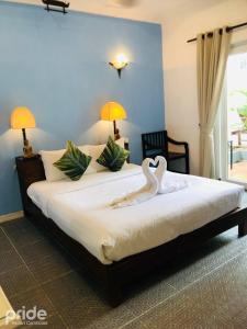 Кровать или кровати в номере Pride Resort Cambodia