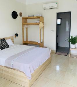 a bedroom with a large bed and a shelf at Della Luna Tam Coc Ninh Binh in Ninh Binh