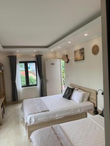 a bedroom with two beds and a window at Della Luna Tam Coc Ninh Binh in Ninh Binh +56 photos