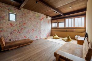a room with a bed and pillows on the floor at Hisago in Kanazawa