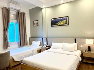 Tempat tidur dalam kamar di A25 Hotel - 185 Lò Đúc