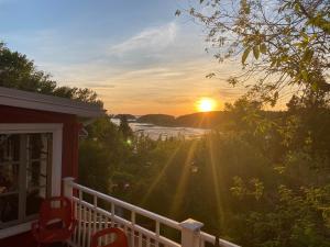 a view of the sunset from the porch of a house at Le Mange Grenouille in Bic +48 photos